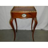 A 19th century French table with Sevres plaques and ormolu gilt mounts.