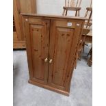 A pine 2 door cupboard.