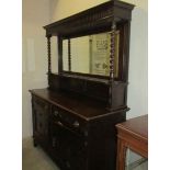 An oak mirror backed sideboard with barley twist supports.