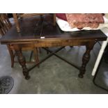 A 1930s oak draw leaf table.