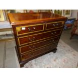 A 2 over 3 mahogany inlaid chest of drawers.