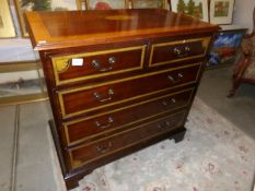 A 2 over 3 mahogany inlaid chest of drawers.