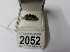 A 9ct gold ring set garnets, size K half.