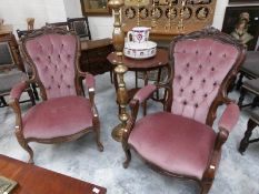 A pair of pink upholstered mahogany framed arm chairs.