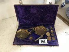 A cased set of precious metal scales.