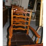 A set of oak ladder back chairs comprising 2 carvers and 4 diners.