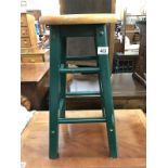 A kitchen stool with green painted base