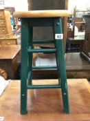 A kitchen stool with green painted base