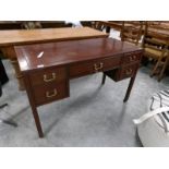 A mahogany desk with brass handles.