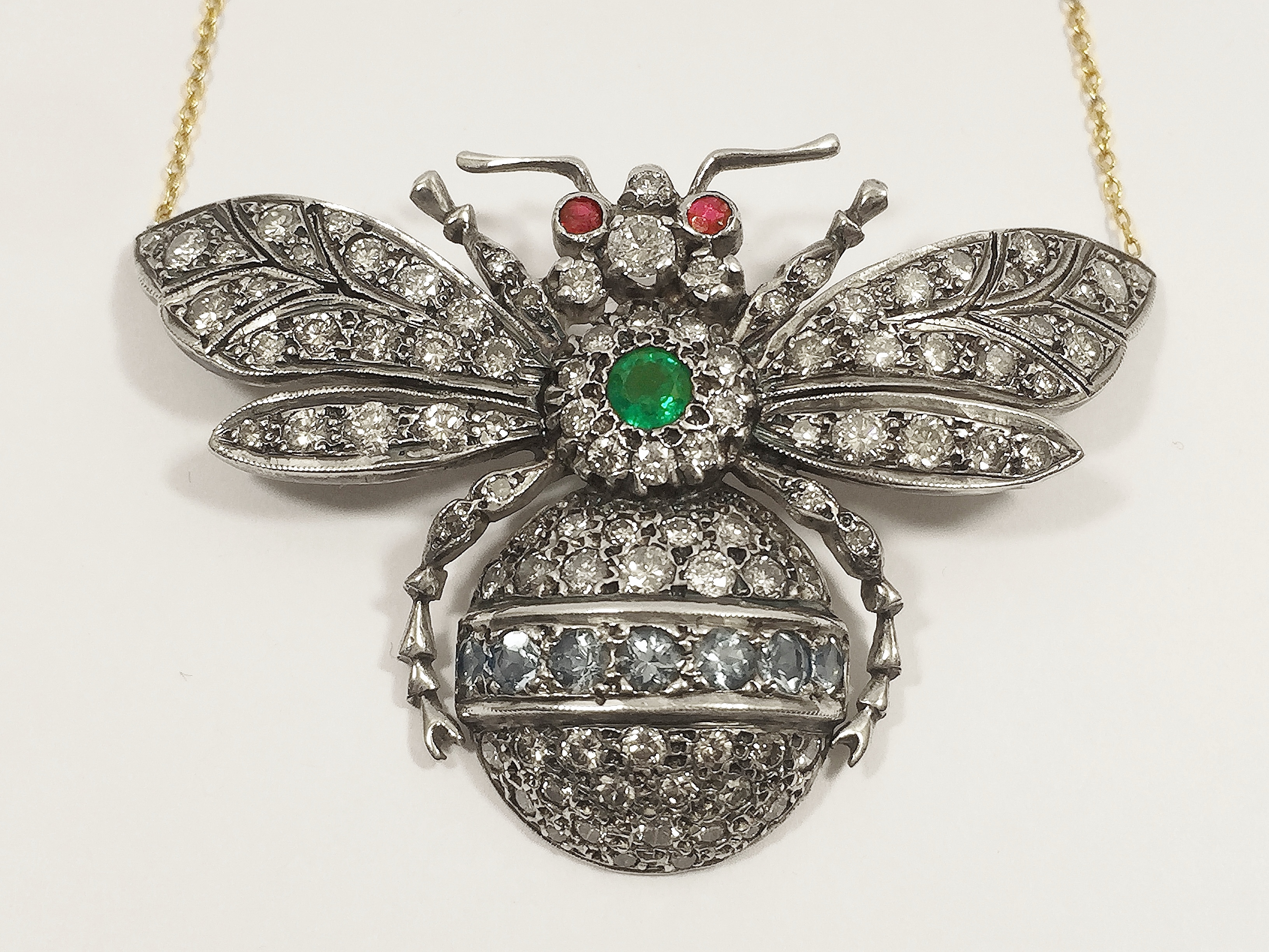 An outstanding 9ct gold 'Bee' pendant with 4 carats of diamonds, central set emerald and ruby eyes.