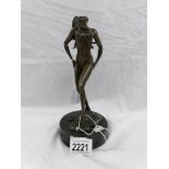 A bronze nude figure.