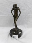 A bronze nude figure.