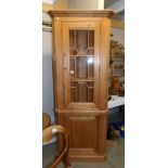 A pine corner cabinet.