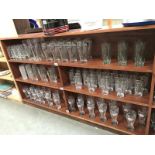 3 shelves of advertising glasses including Baileys, Pernod, Kronenburg, Bacardi & Coca-Cola etc.