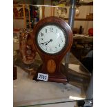 A mahogany inlaid clock.