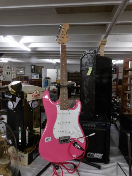 A pink Westfield Strat guitar with lead and 15w crate amp.