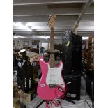 A pink Westfield Strat guitar with lead and 15w crate amp.