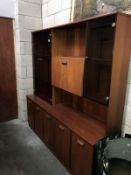 A teak effect wall unit with glass doors.