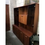 A teak effect wall unit with glass doors.