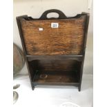 A 1930s oak magazine rack.