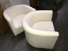 A pair of tub chairs.