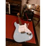 A blue Strat style guitar with a Gorilla 20w amp and lead.