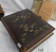 A Victorian photograph album containing photographs together with a packet of negatives.
