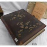 A Victorian photograph album containing photographs together with a packet of negatives.