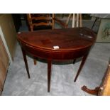 A Victorian mahogany D shaped fold over games table with string inlay.