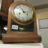 An early 20th century oak mantel clock in working order.