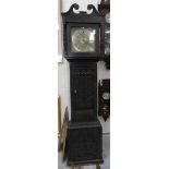 A carved oak 30 hour long case clock with brass dial.