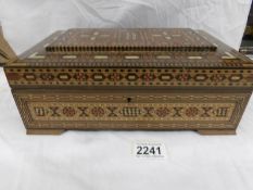 A good quality inlaid box featuring many different woods.