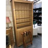 A pine display cabinet and suitcase stand.