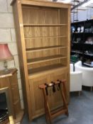 A pine display cabinet and suitcase stand.