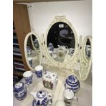 A three fold bedroom mirror with decorative frame.