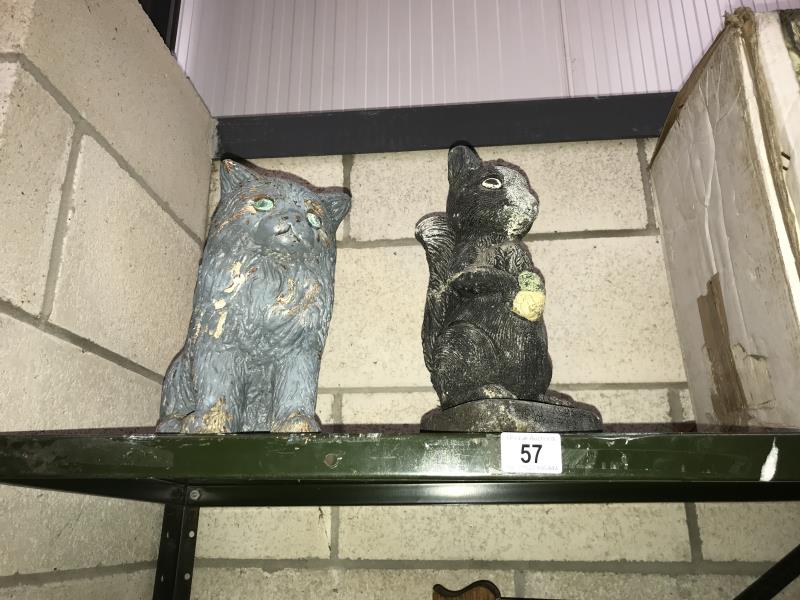 2 concrete garden ornaments being a cat and a squirrel.