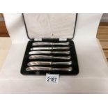 A cased set of silver handles butter knives.
