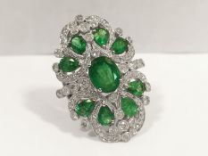 An outstanding 18ct white gold ring set diamonds and stunning emeralds, 9 emeralds 4.