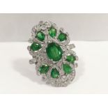 An outstanding 18ct white gold ring set diamonds and stunning emeralds, 9 emeralds 4.