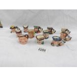 12 miniature Royal Doulton character jugs.