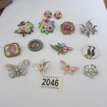 12 mid 20th century brooches and a pair of earrings.