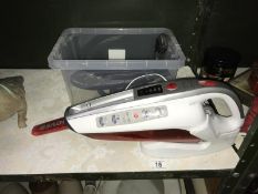 A Hoover Jobis and a a portable hand held vacuum cleaner.