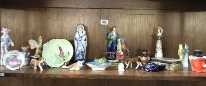 A mixture of pottery and porcelain ornaments including spectacled Grandma figure.
