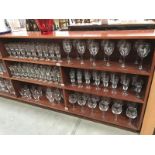 3 shelves of advertising glasses including Cherry B, Pony & Stowells etc.