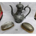 A pair of hall marked silver backed brushes and a pewter coffee pot.