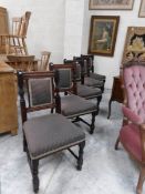 A set of 10 mahogany dining chairs with upholstered tops and backs.