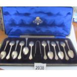 A cased set of 12 silver teaspoons with sugar tongs.