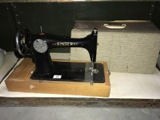 A cased Singer sewing machine.