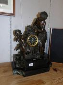 A large French bronze and marble mantel clock.