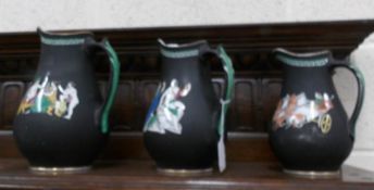 A set of 3 graduated jugs decorated with Roman scenes.